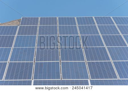 Solar Panel Installation On Asphalt Shingles Rooftop