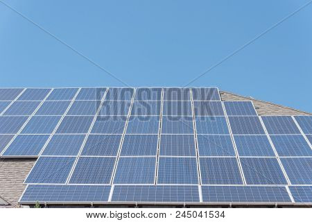 Solar Panel Installation On Asphalt Shingles Rooftop