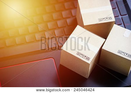 Online Shopping Concept E-commerce Delivery Buying Service. Square Cartons Shopping On Laptop Keyboa