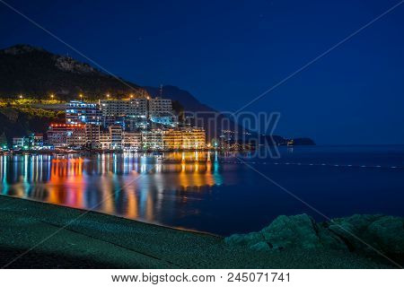 Montenegro, Rafailovici - June 05/2017: Tourists Walk Along The Picturesque Night Embankment On The