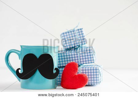 Happy Fathers Day Concept. Stack Of Beautiful Gift Box With Handmane Red Heart, Mustache And Bow Tie