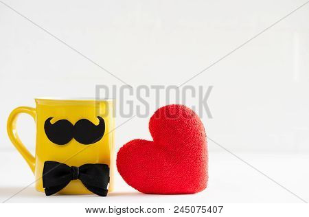 Happy Fathers Day Concept. Handmane Red Heart With Mustache And Bow Tie On Yellow Pastel Coffee Cup 