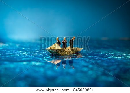 Miniature Figurine Businessmen Ride On Dollar Bill Origami Yacht