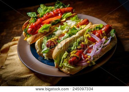 Fancy Grilled Hotdogs With Many Toppings Including Relish And Sauerkraut
