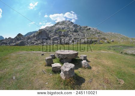 round stone table and stone seats in Moraca Mountains, Montenegro 