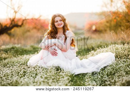 A Girl Is Walking Among The Blooming Peaches