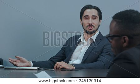 Hispanic Latin Businessman Communicating With Afro American Partner In The