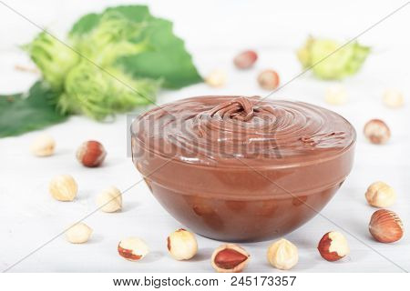 Homemade Hazelnut Spread In Glass Bowl With Nuts And Green Hazelnut Branch. Nutella Nougat Cream