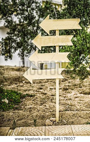 Direction Indicator. Wooden Signpost. Directions Four Signs To One Place Or Way