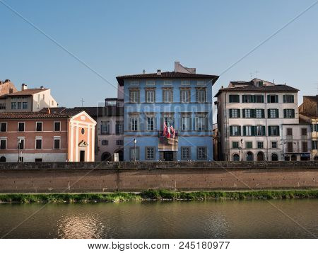 Heritage Buildings In Pisa And The Arno River On A Sunny Day
