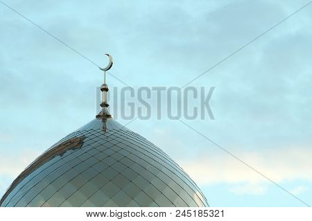 The Symbol Of Islam Is A Golden Crescent Moon On Top Of The Mosque. Minaret On The Blue Morning Sky 