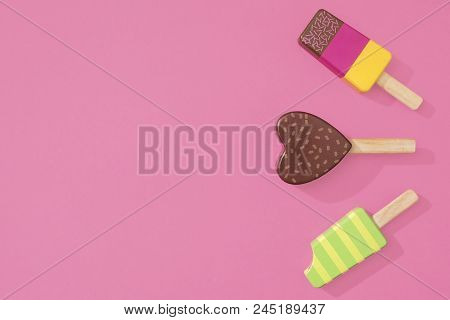 Ice Cream Popsicles Lollipops On A Pastel Pink Background Ready For Summer.   Wooden Toy Ice Lolly