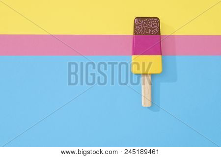 Ice Cream Popsicle Lollipop On A Pastel Background Of Three Colours Ready For Summer.  Wooden Toy Ic