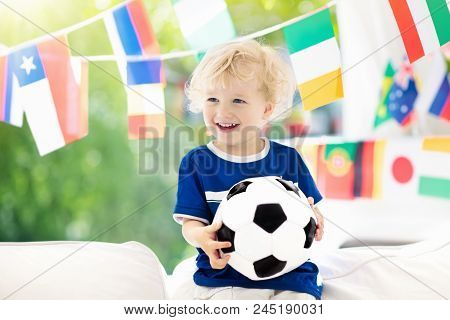 Child Watching Football Game On Tv. Little Boy In Brazil Tricot Watching Soccer Game During Champion
