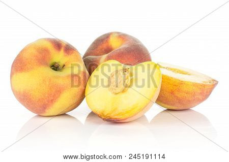 Two Yellow Peaches With One Cut In Half Isolated On White Background