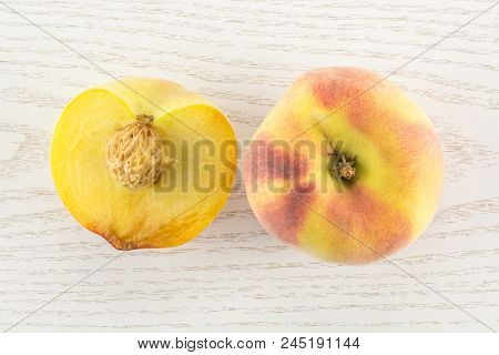 One Yellow Peach And A Half With A Drupe Flatlay On Grey Wood Background