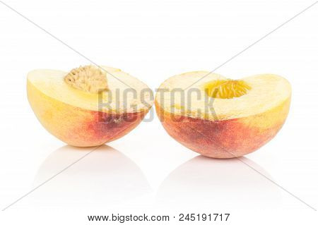 Two Halves Of Yellow Peach Isolated On White Background Cross Section With A Drupe Inside