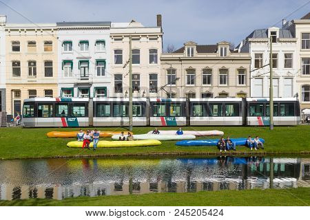 Coolsingel, Rotterdam, The Netherlands - April 7 2018: Tram On Busy Coolsingel, People Relaxing On A