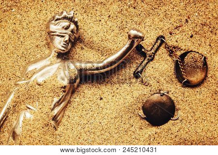 Statue Of Lady Justice With Scale Buried In Sand, Concept Of Unsolved Cold Case Crime