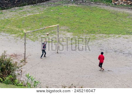 GHALEGAUN, NEPAL - CIRCA MAY 2018: chidren play football. The goal is made of tree branches.