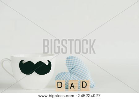 Happy Fathers Day Concept. Handmane Red Heart With Mustache And Bow Tie On Coffee Cup With Wooden Bl