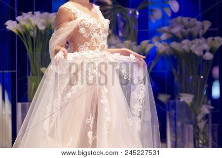 Sofia, Bulgaria - 28 March 2018: Female Model Walks The Runway In White Dress During A Fashion Show.