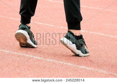 H A White Outsole Stood On Her Toes On The Sports Ground. Fitness Classes Or Warm-up Before Running 