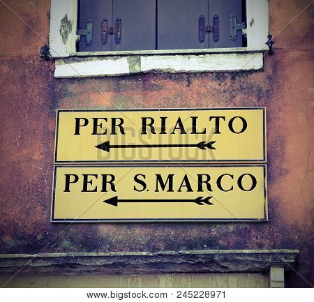 Venice In Italy And The Italian Road Sign To Go To Saint Mark Square Or Rialto Bridge With Vintage E