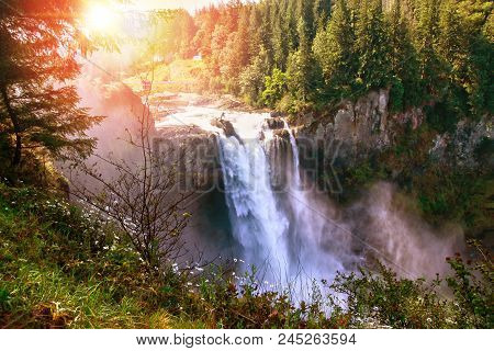 Morning Sun Peeks Through The Trees At Snoqualmie Falls In Washington State Near Seattle. The Waterf