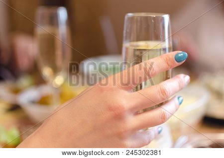 Woman Hand Holding A Wine Glass And Speaking The Toast. Congratulatory Speech.