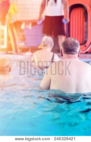Group Or Young And Senior People In Aquarobic Fitness Swimming Pool Exercising Water Sport