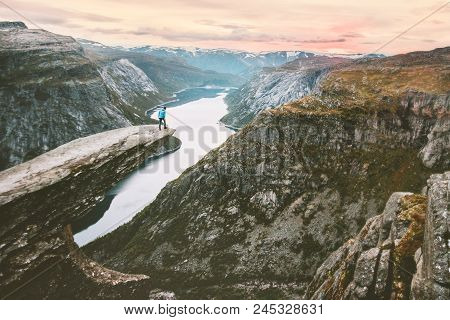 Traveler Alone On The Edge Of Trolltunga Cliff Travel In Norway Adventurous Lifestyle Extreme Journe
