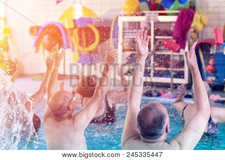 Group Or Young And Senior People In Aquarobic Fitness Swimming Pool Exercising Water Sport
