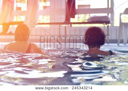 Group Or Young And Senior People In Aquarobic Fitness Swimming Pool Exercising Water Sport