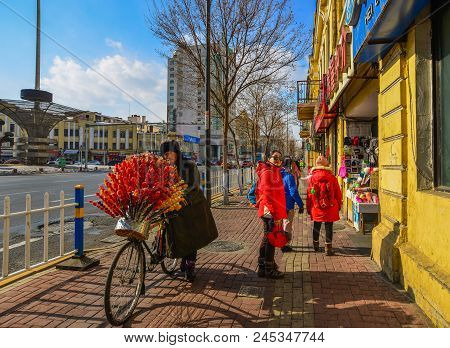 Harbin, China - Feb 22, 2018. A Vendor With Bicycle Selling Candied Fruits (tanghulu) In Harbin, Chi