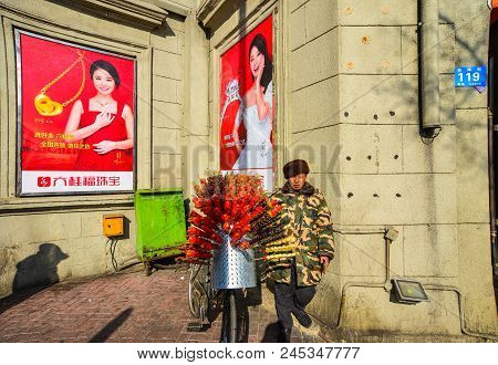 Harbin, China - Feb 22, 2018. A Vendor With Bicycle Selling Candied Fruits (tanghulu) In Harbin, Chi