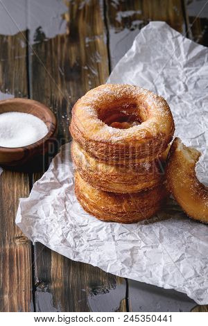 Homemade Puff Pastry Deep Fried Donuts Or Cronuts In Stack With Sugar Standing On Crumpled Paper Ove