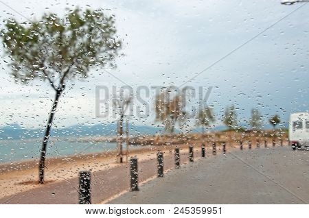 Cobble Stone Street Along Ocean Trees And Raindrops On Car Window In Palma De Mallorca, Spain In Nov