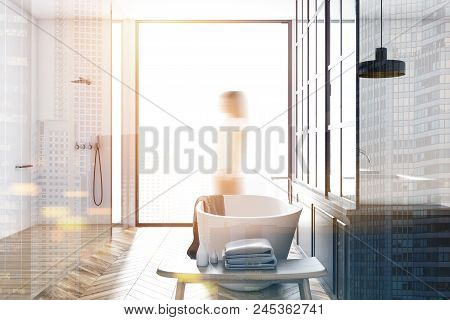 White Wall Bathroom Interior With A Wooden Floor And A White Tub With A Mirror. A Double Sink. A Wom