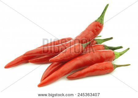 red and green rawit peppers (Capsicum annuum 'Bird's Eye') on a white background