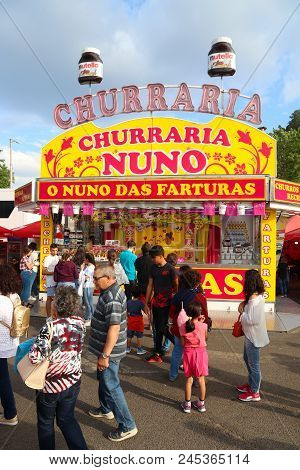 Leiria, Portugal - May 22, 2018: People Buy Traditional Fried Dough Pastry Churros For The City Cele