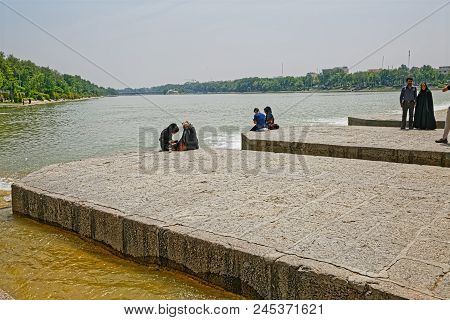 Isfahan, Iran - May 8, 2015: People Resting And Enjoying The View Of The Zayandeh River From The Anc