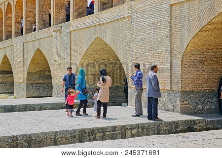 Isfahan, Iran - May 8, 2015: People Enjoying The View Of The Zayandeh River From The Ancient Khaju B