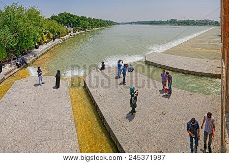 Isfahan, Iran - May 8, 2015: People Resting And Enjoying The View Of The Zayandeh River From The Anc