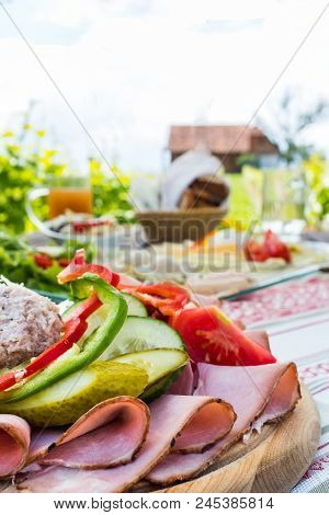 Brettljause, Traditional Cold Plate With Meat, Cheese, Fish, Vegetable, Bread And Drinks On Wooden T