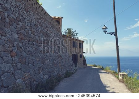 2018, 12 May, Banyalbufar, Majorca, Spain. Road To The Mediterranean Sea And Street Lamp. Banyalbufa