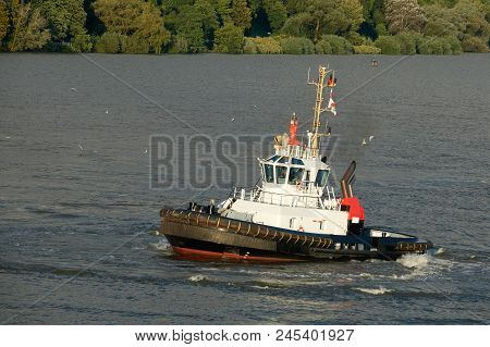 Tugboat Of Red And White Color In The River.