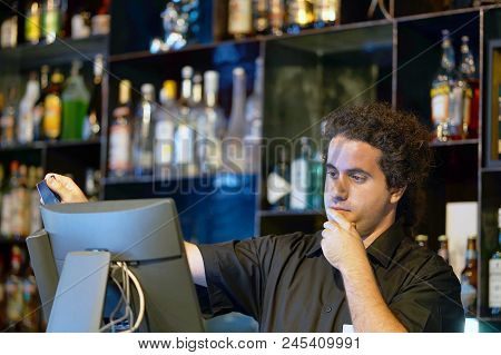 Registration Male Of Bartender Employee Of A New Order By A Cash Register. The Barman Pays The Order