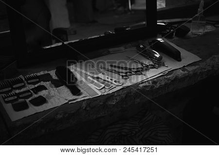The Tools Of A Barber On The Desktop In Front Of The Mirror .black And White Photo Of Hairdresser To