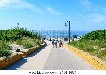 KRYNICA MORSKA - MAY 28: Tourists enjoy the sunny weather are going to the beach on 28 May 2018 in Krynica Morska, Poland.